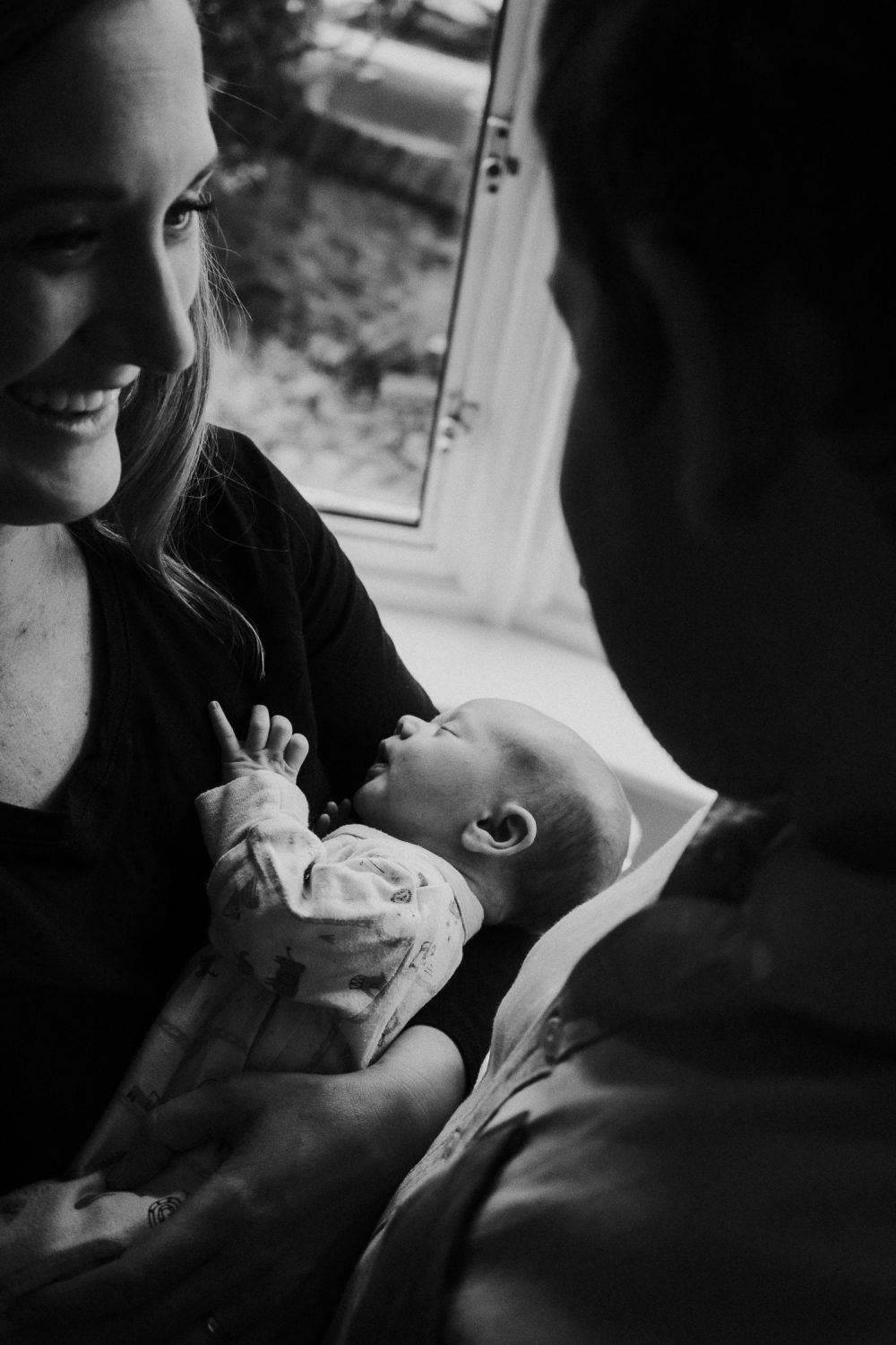 newborn photo session at home in highgate black and white photo of baby boy and parents