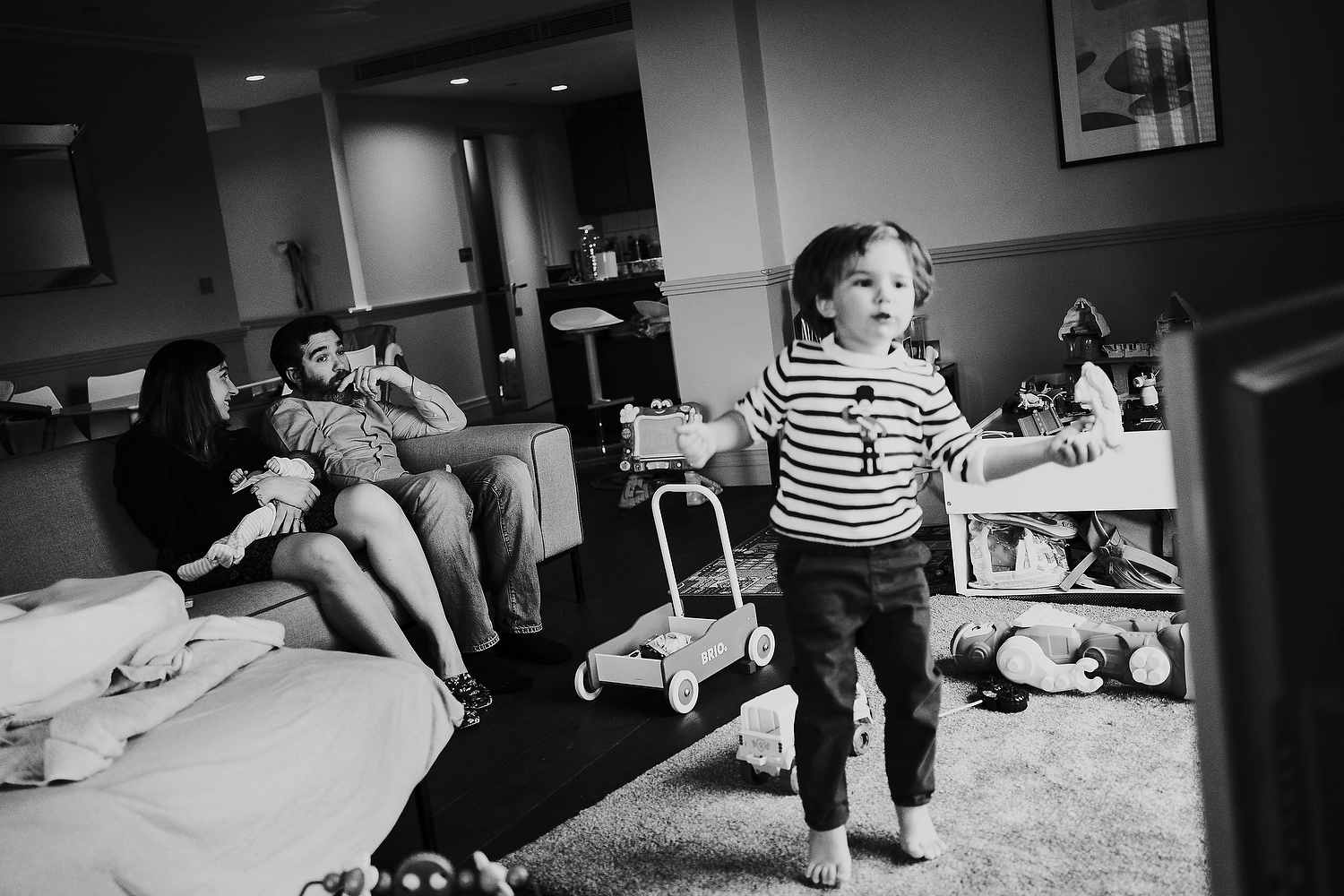 black and white family living room scene newborn photography in hammersmith