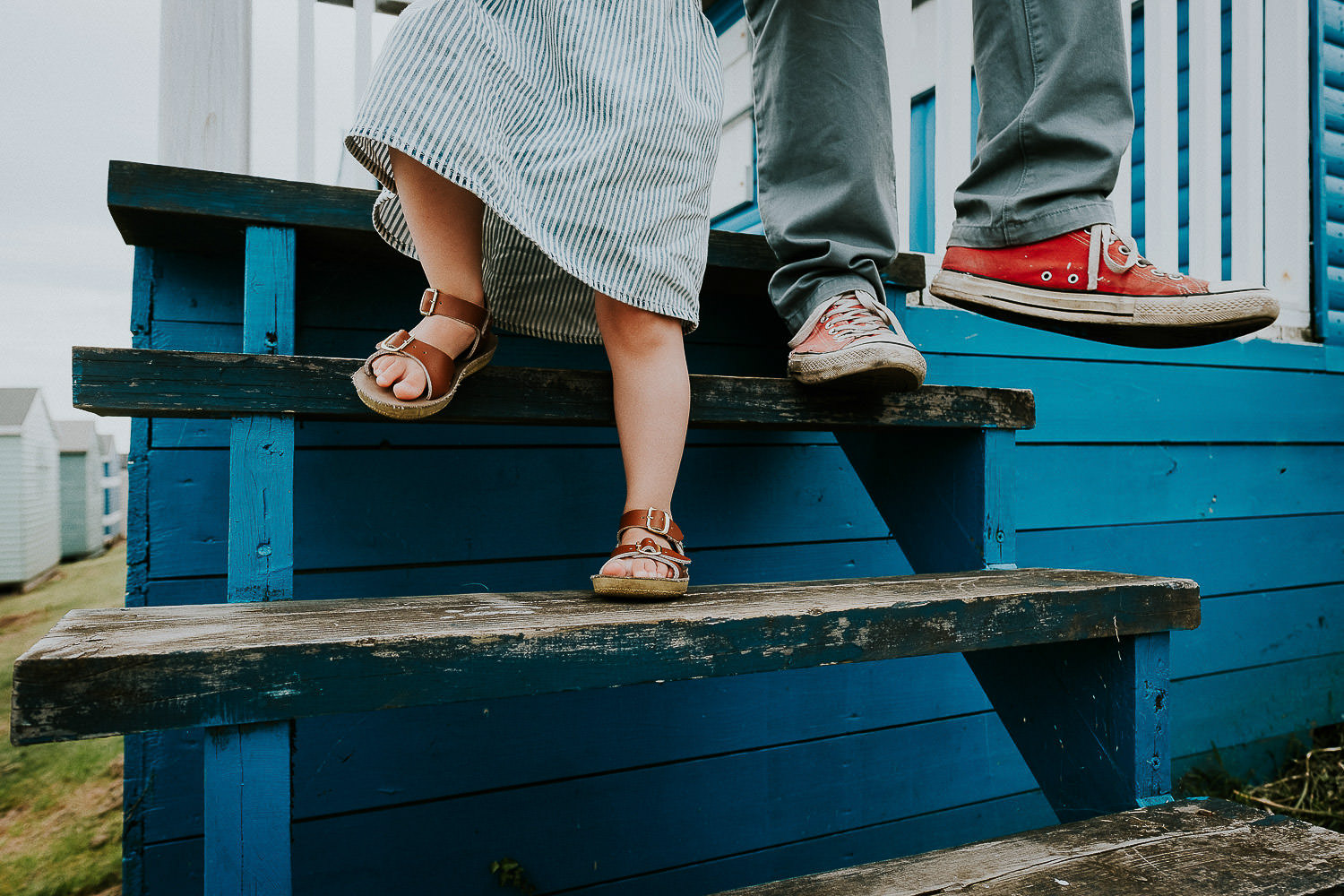 BEST BEACH DAYS OUT FROM LONDON WHITSTABLE FAMILY PHOTO FEET ON BEACH HUT STEPS