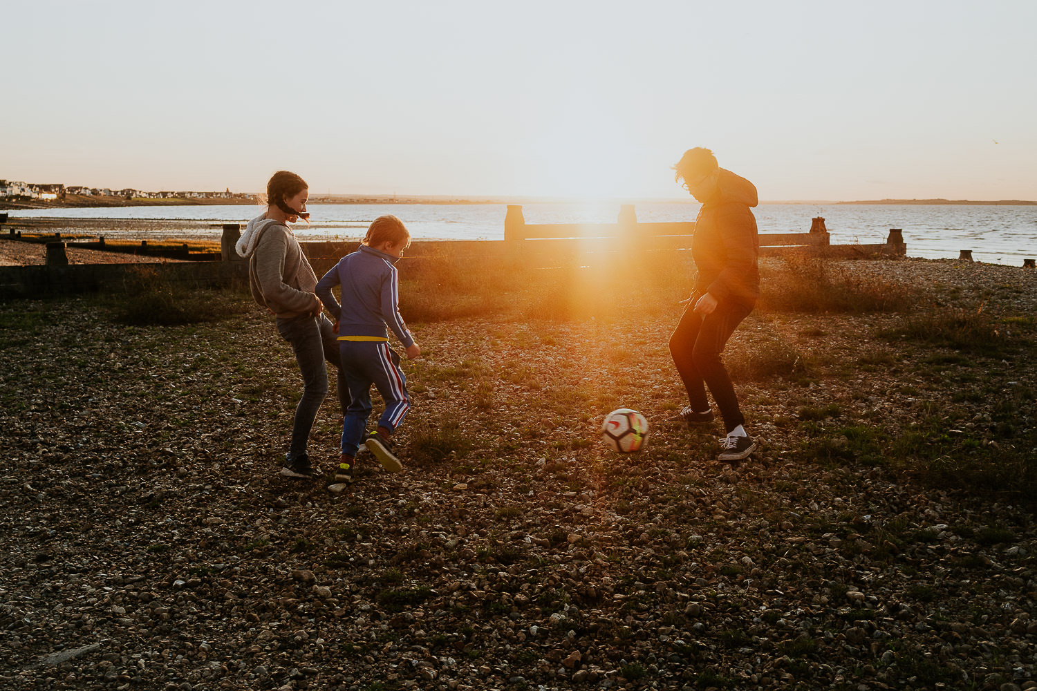 BEST BEACH DAYS OUT FROM LONDON WHITSTABLE FAMILY CHILDREN PLAYING FOOTBALL ON BEACH