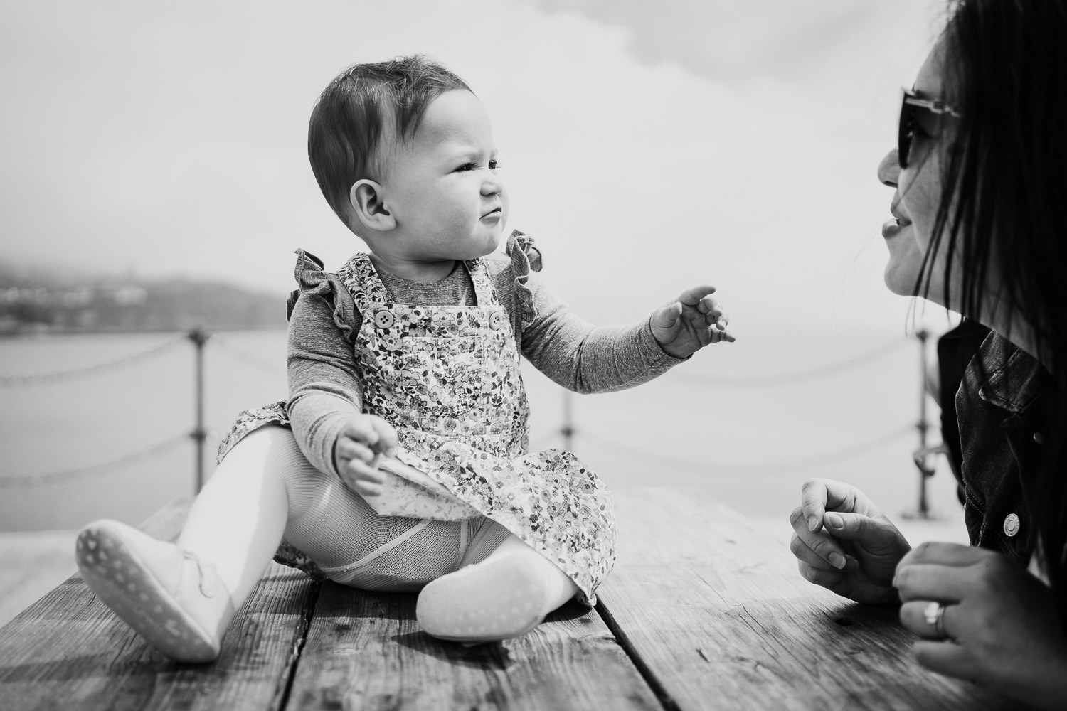 folkestone family photo shoot on the beach toddler girl sitting on picnic bench