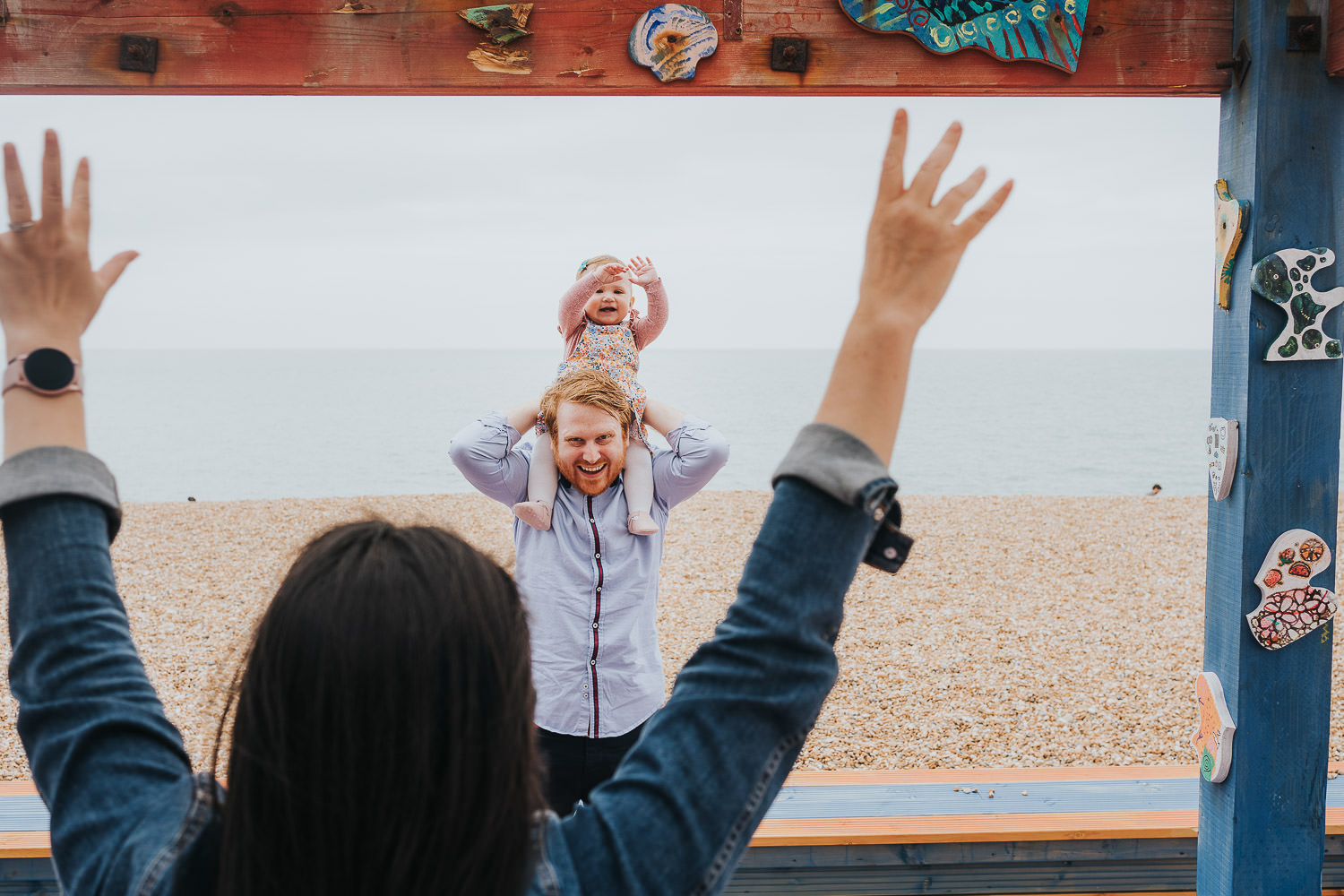 folkestone family photo shoot on the beach family with toddler girl enjoying triennial artworks