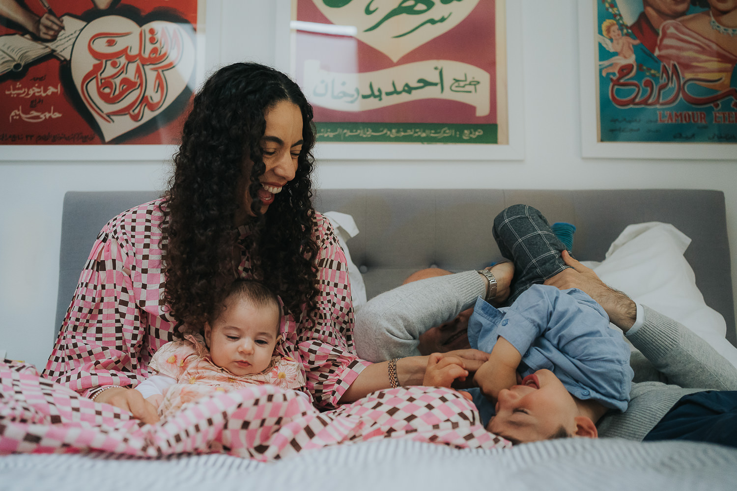 bayswater family photo shoot family on bed playing games and laughing