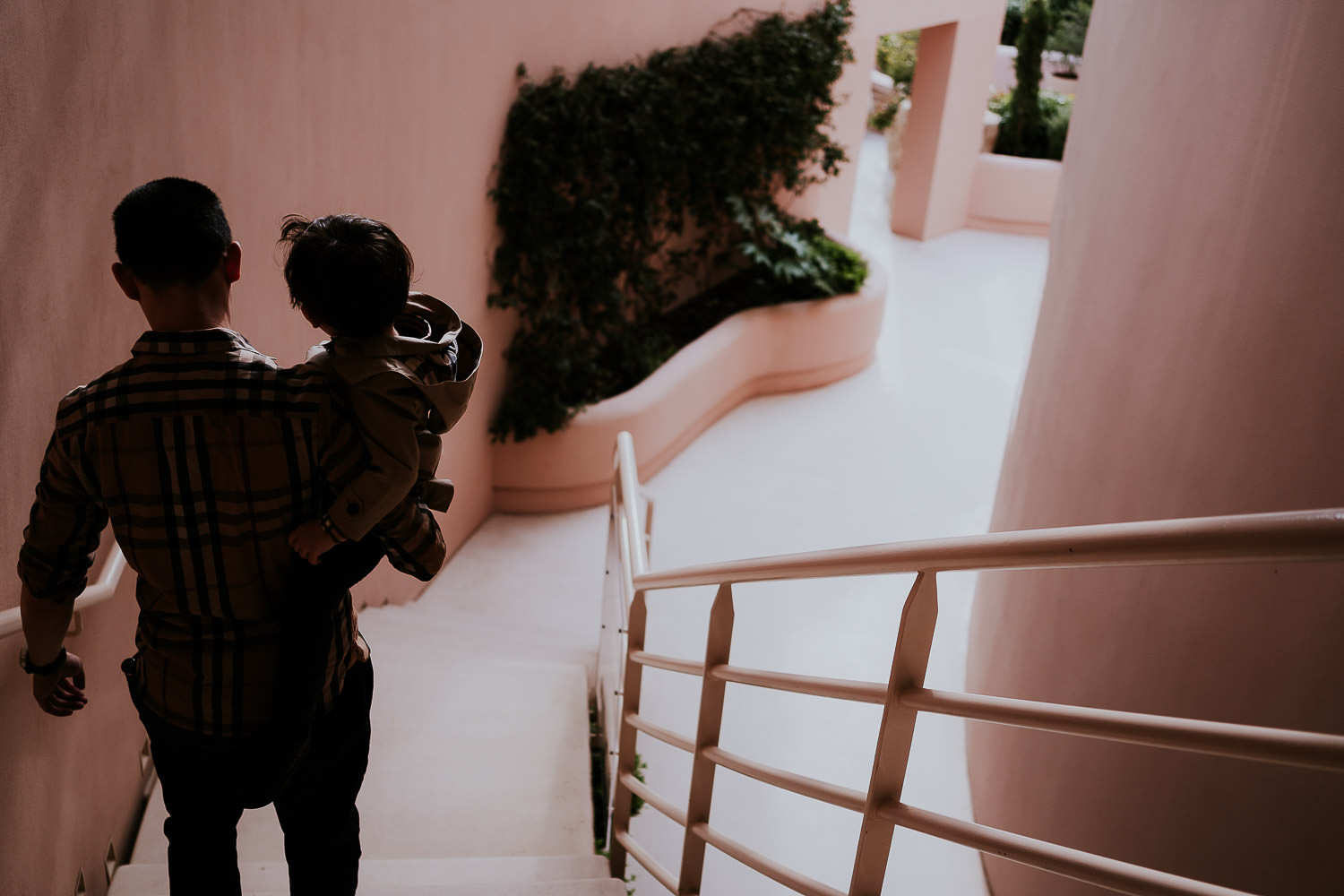 father and son walking down stairs at a family vacation photo shoot in the south of france grand hotel du cap ferrat