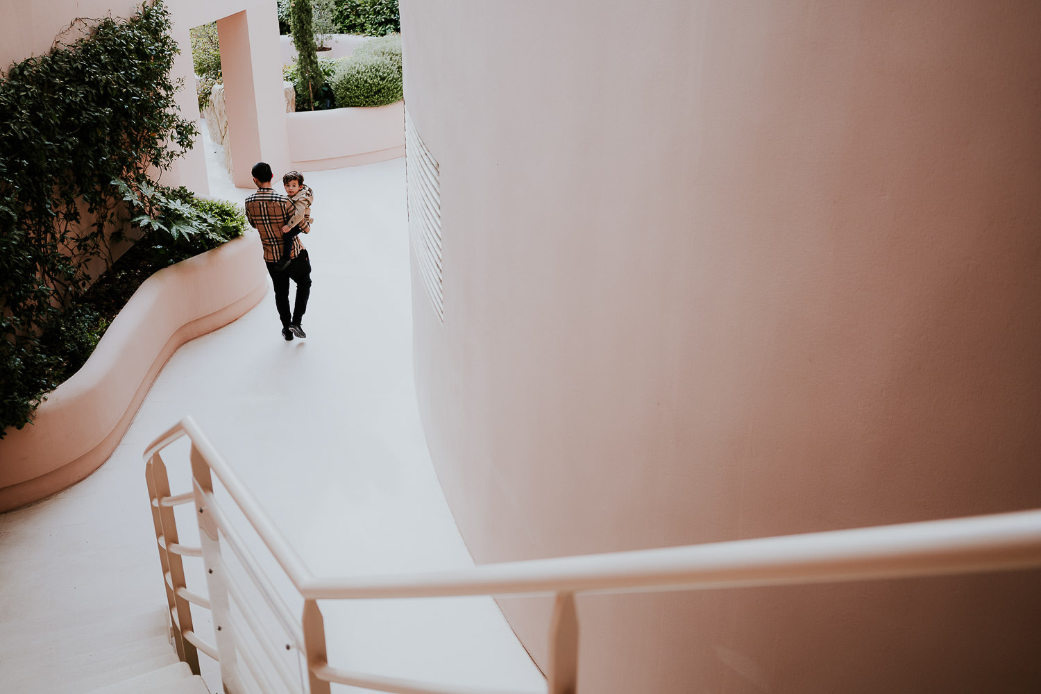 father and son walking from behind at a family vacation photo shoot in the south of france grand hotel du cap ferrat