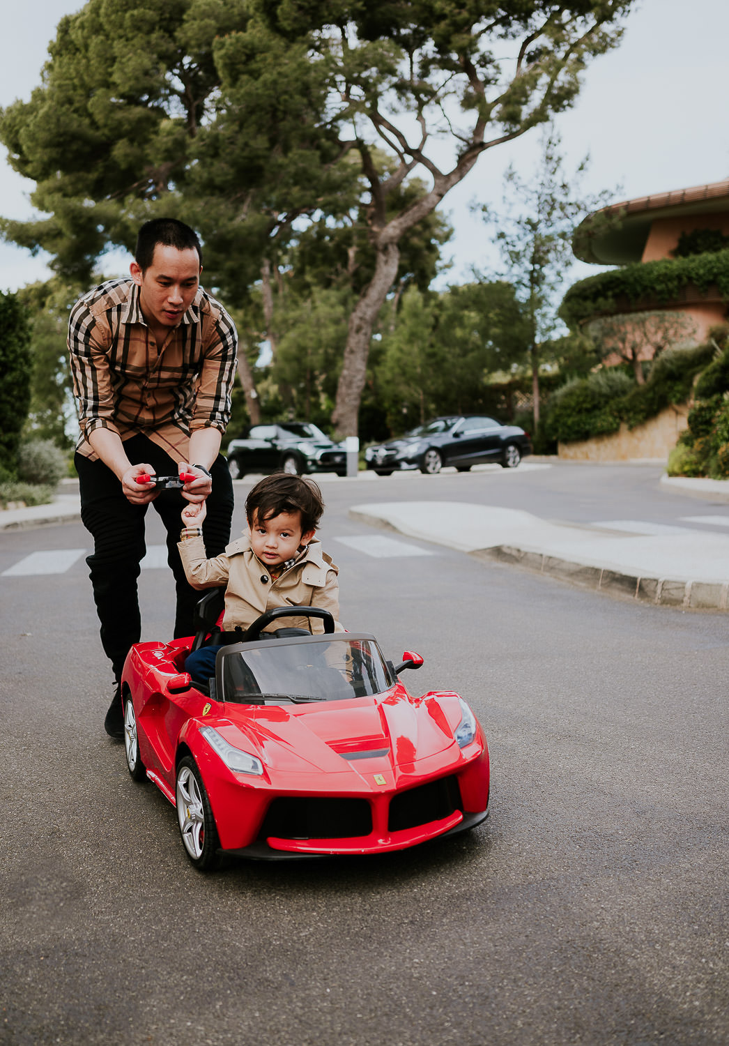 little boy driving kids sports car at a family vacation photo shoot in the south of france grand hotel du cap ferrat