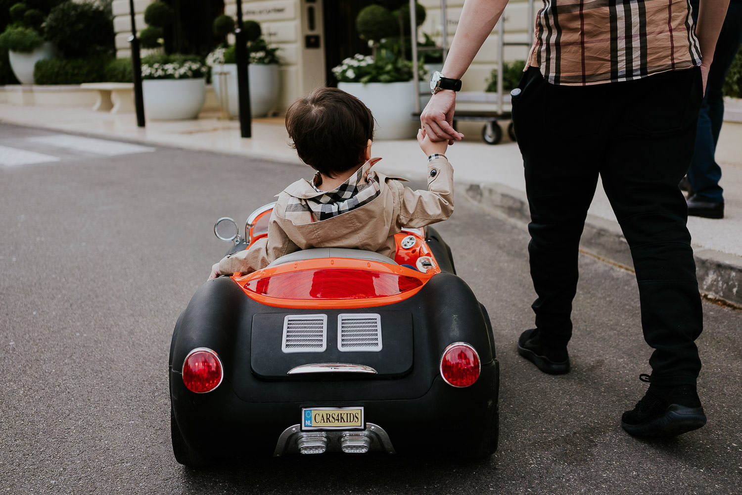 little boy driving kids sports car at a family vacation photo shoot in the south of france grand hotel du cap ferrat
