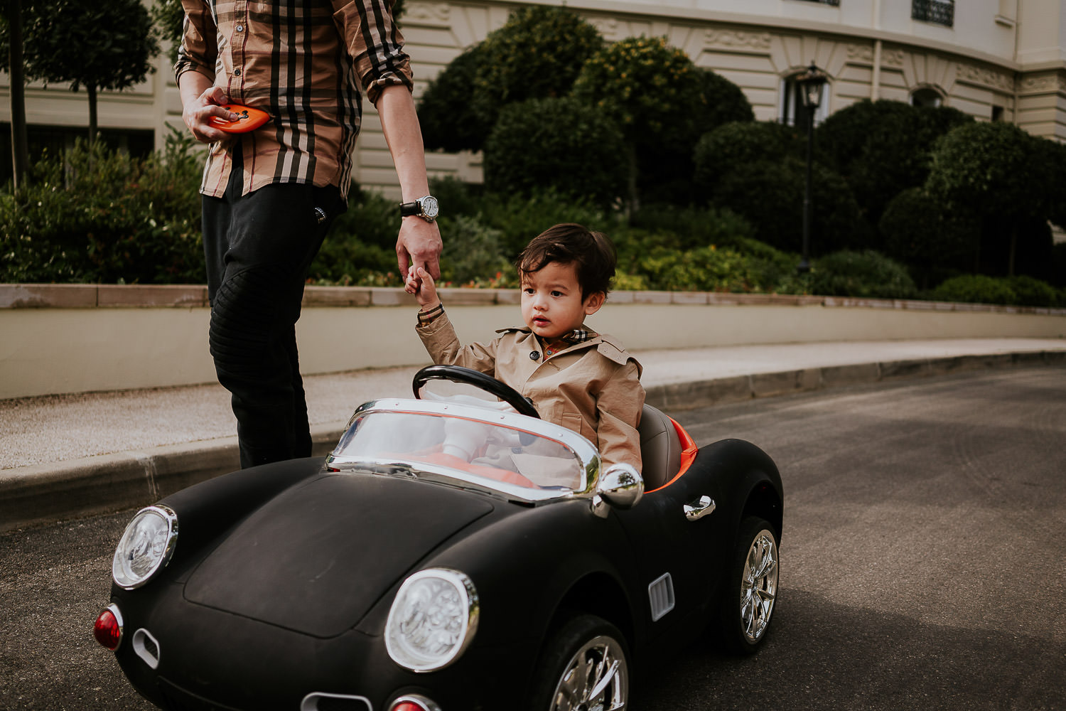 little boy driving kids sports car at a family vacation photo shoot in the south of france grand hotel du cap ferrat