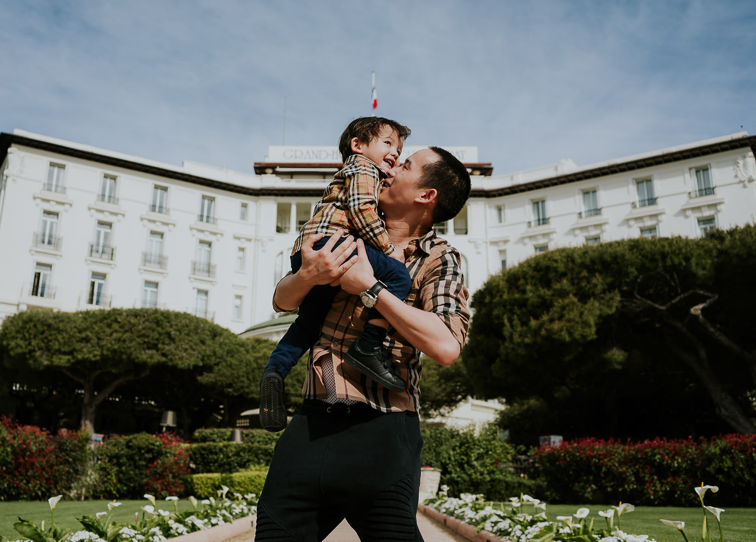 father and son in hotel gardens at a family vacation photo shoot in the south of france grand hotel du cap ferrat