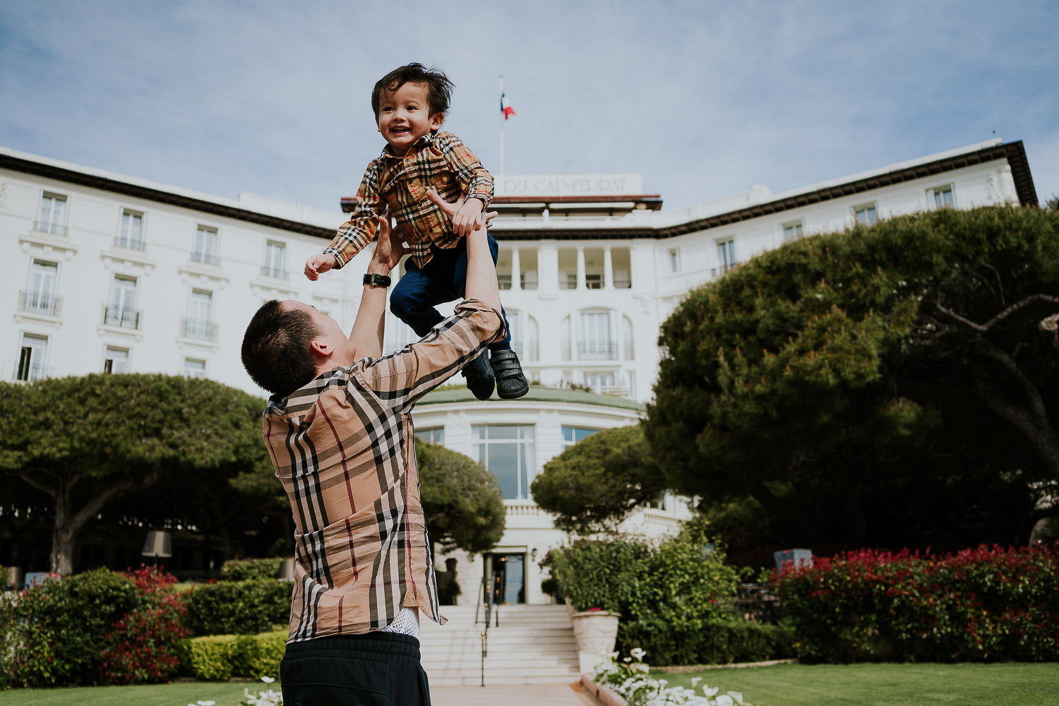 father and son in hotel gardens at a family vacation photo shoot in the south of france grand hotel du cap ferrat