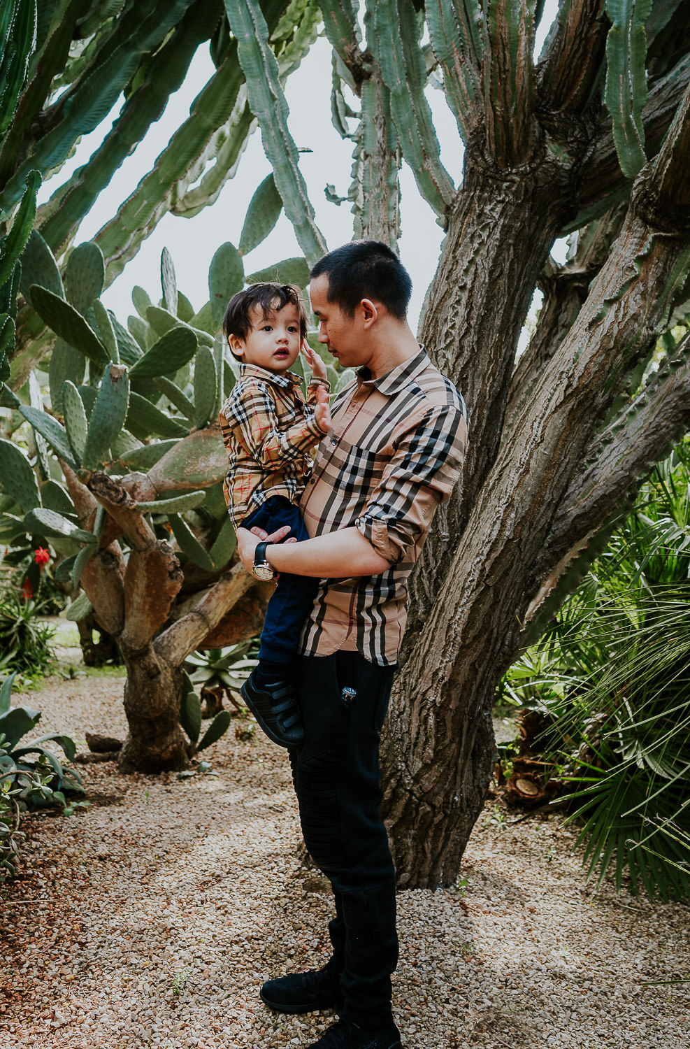 father and son in hotel gardens at a family vacation photo shoot in the south of france grand hotel du cap ferrat
