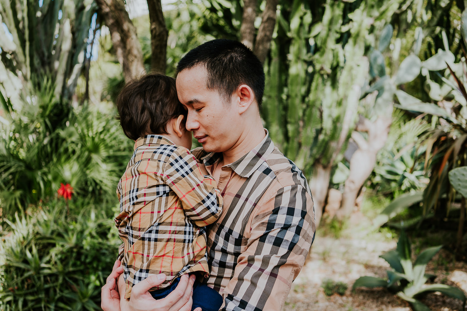father and son in hotel gardens at a family vacation photo shoot in the south of france grand hotel du cap ferrat