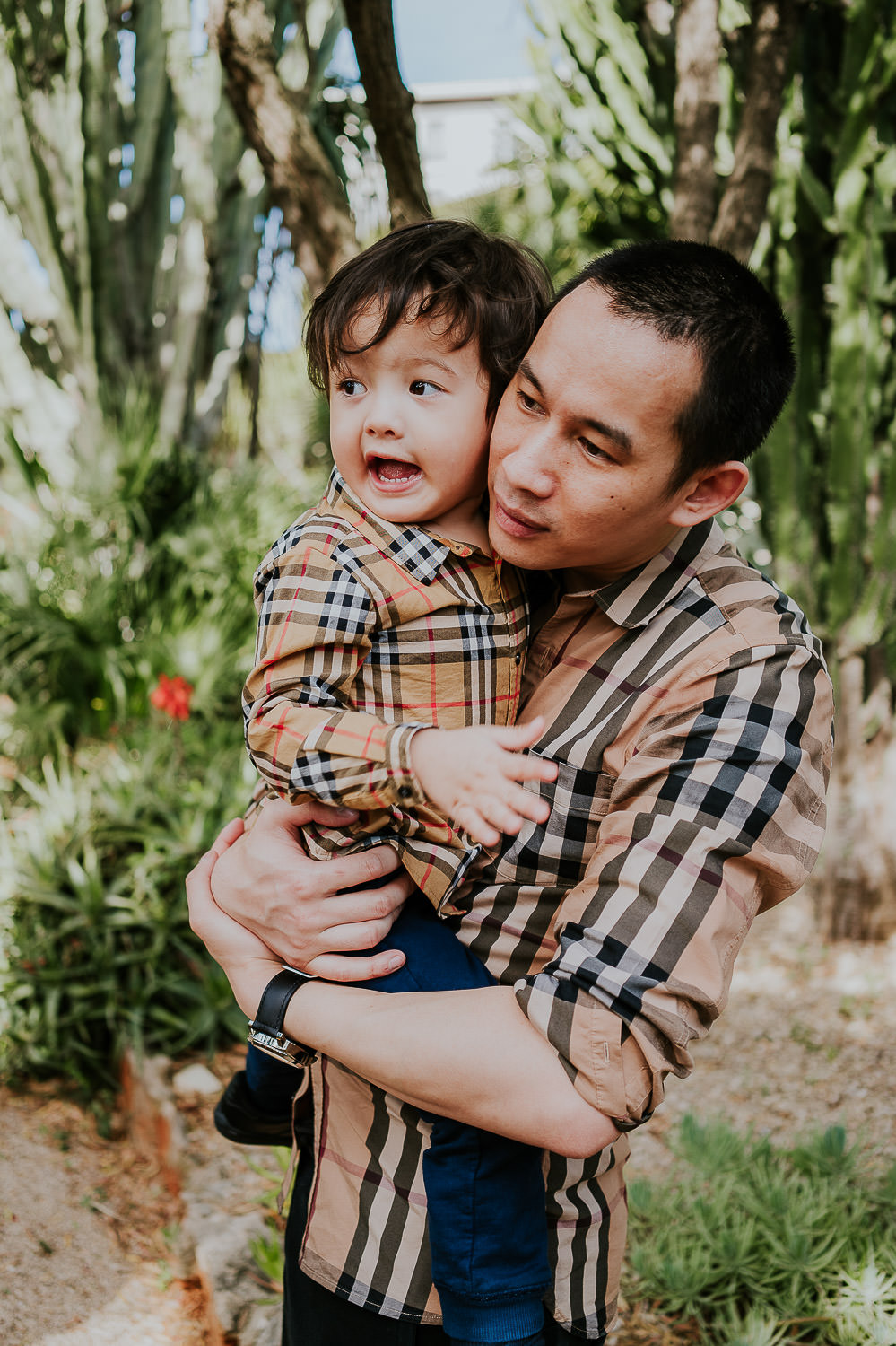 father and son in hotel gardens at a family vacation photo shoot in the south of france grand hotel du cap ferrat