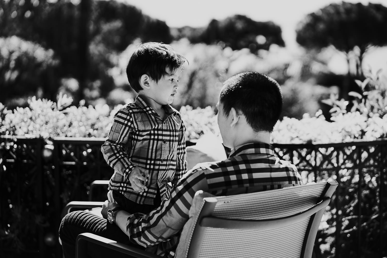 father and son in hotel gardens at a family vacation photo shoot in the south of france grand hotel du cap ferrat