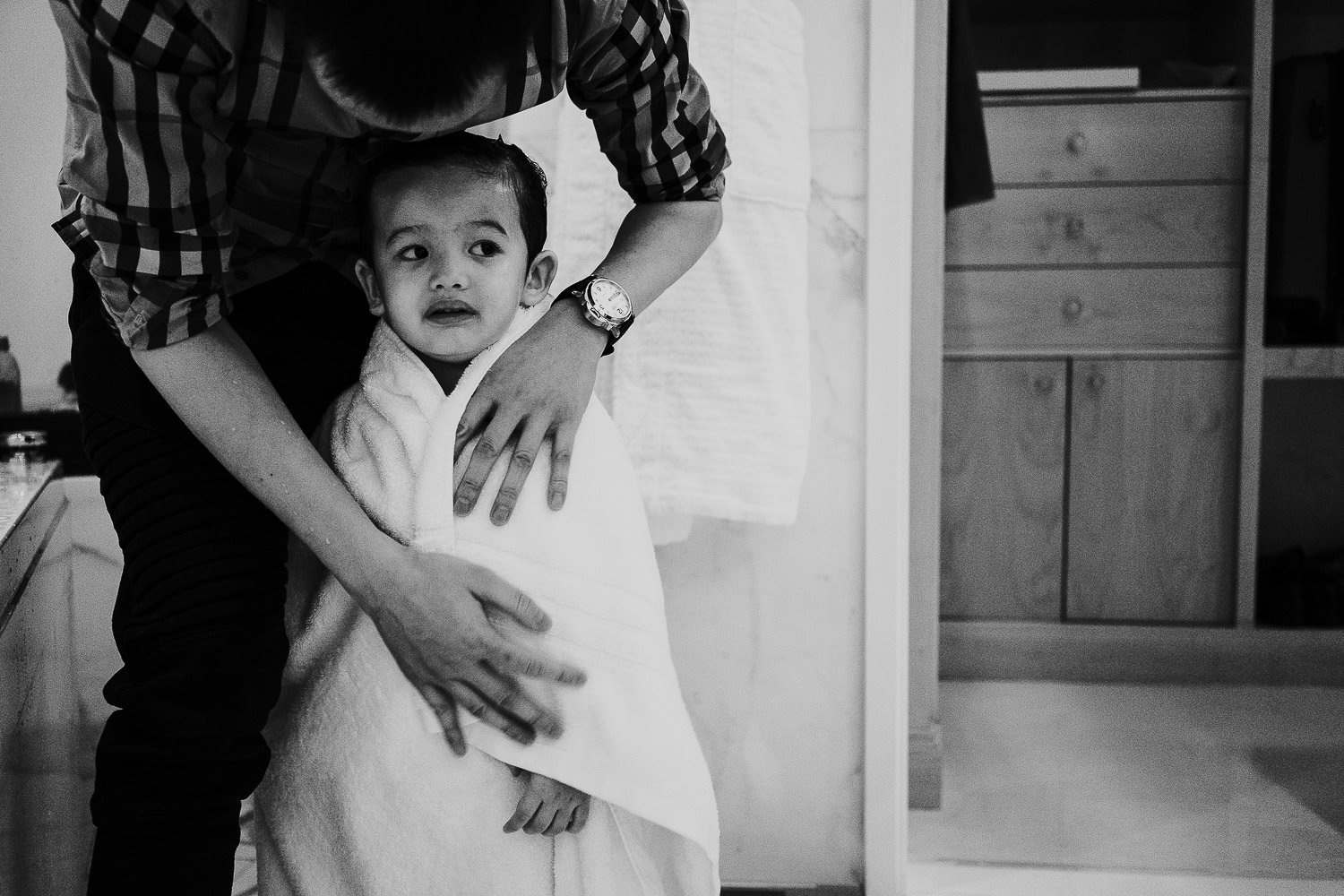 family vacation photo shoot in the south of france grand hotel du cap ferrat four seasons little boy wrapped in bath towel in hotel room