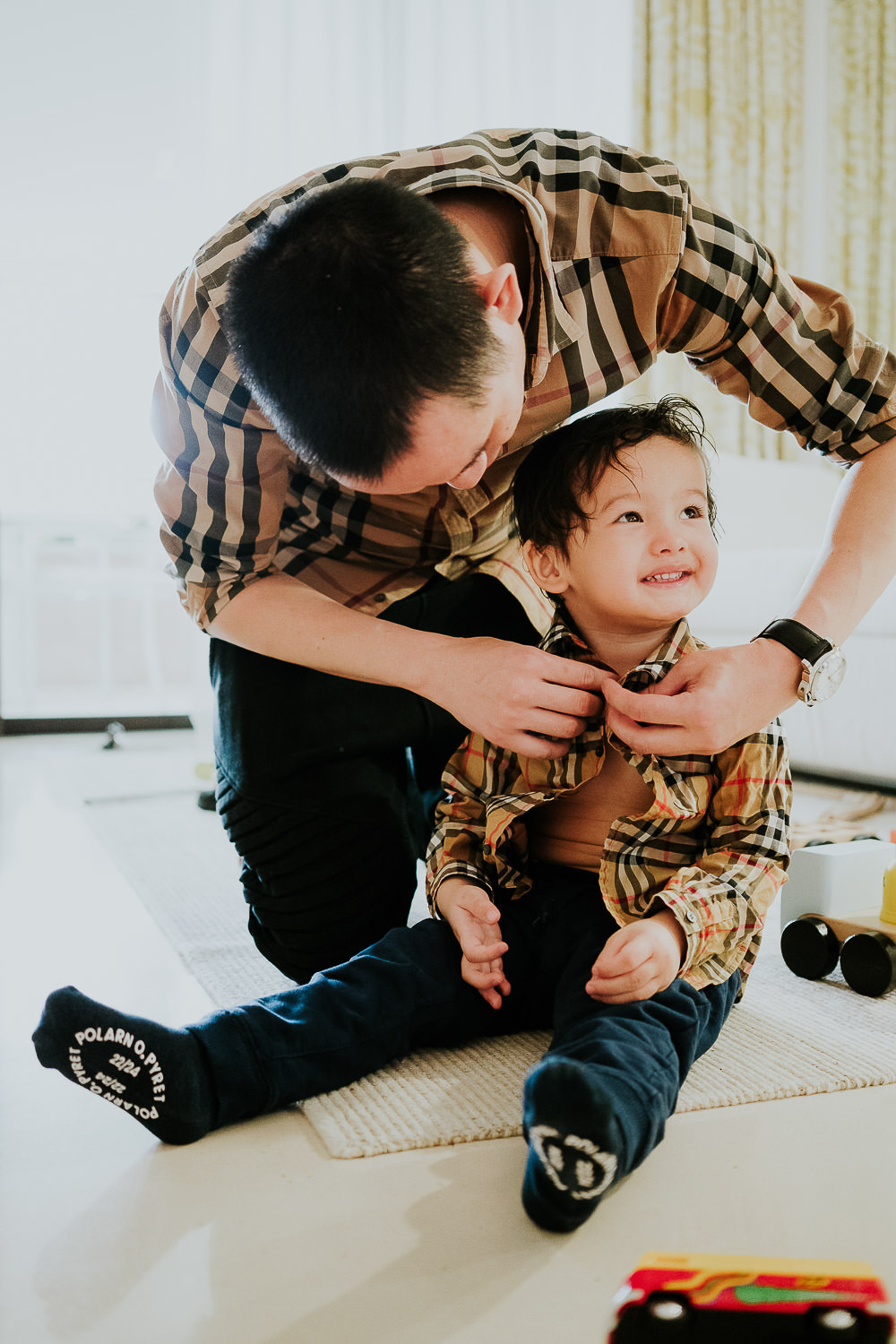 father dressing little son at a family vacation photo shoot in the south of france grand hotel du cap ferrat